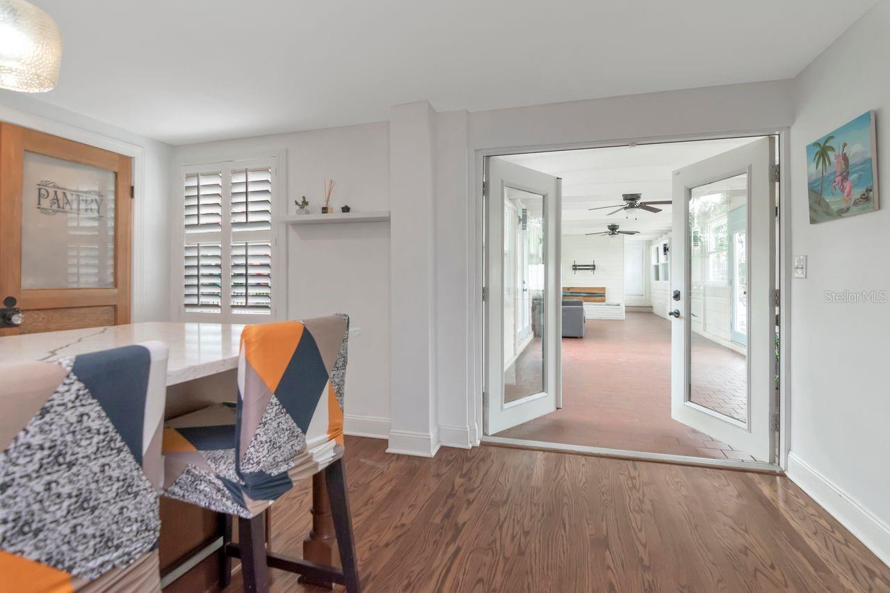 Double Glass Door Entry to Custom Built Breezeway off of the Kitchen - the ultimate entertainment space connecting from the Kitchen!