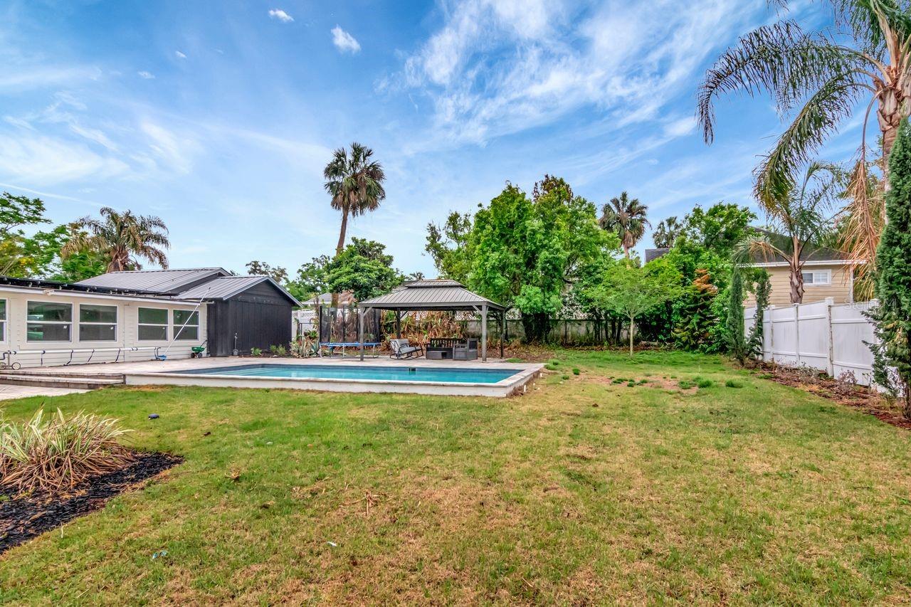 View of Backyard, Pool, Gazebo, Breezeway and Fully Fenced.