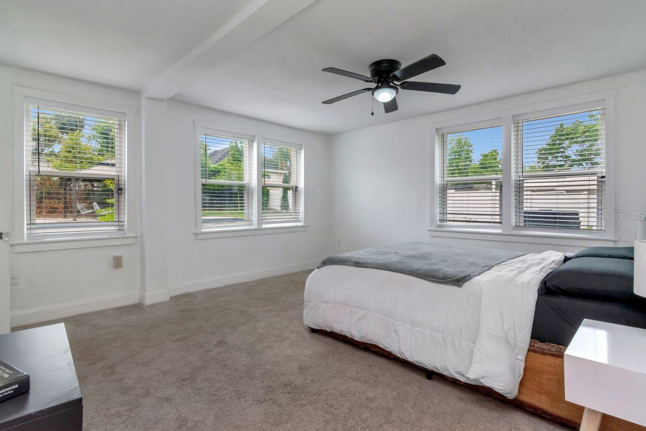 Primary Bedroom with New Carpet (04/08), En-Suite Bathroom, 2 Walk In Closets, Plenty of Windows, Natural Light, Ceiling Fan.