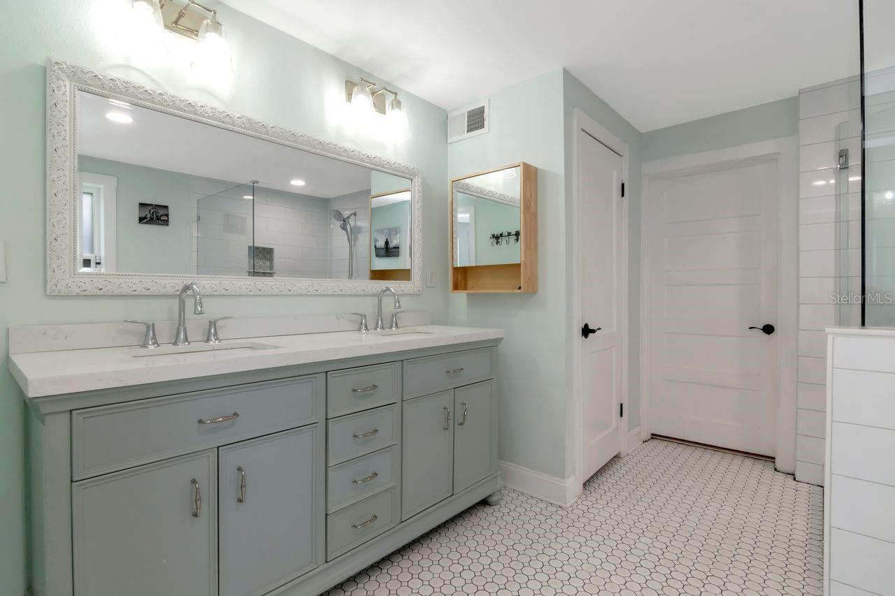 En-Suite Primary Bathroom with Dual Vanities, Upgraded Cabinets, Fixtures/Hardware, Upgraded Tile, Tile  surrounding Claw Bathtub, Large Shower Stall all tiled, Private Water Closet, Access Door to Laundry Room