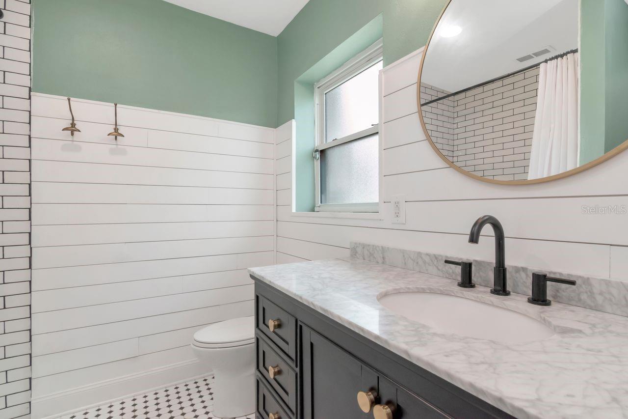 Full Bathroom Downstaris, Quartz Countertops, Upgraded Fixtures, Hardware, Custom Shiplap and Decorative Tile Floor.