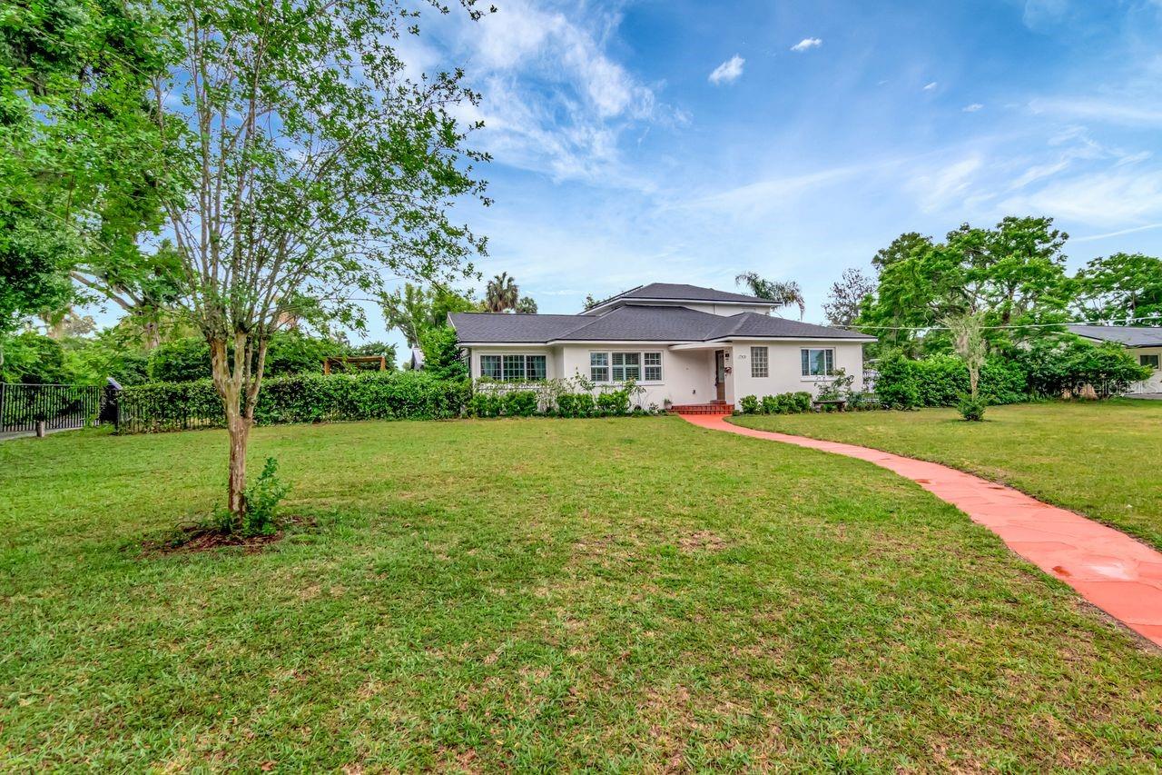 Front of Home and Walkway to Steps and Front Door with Covered Entry. Oversized Lot - Expansive Front Yard - Beautiful Walkway to Entrance of the Home.