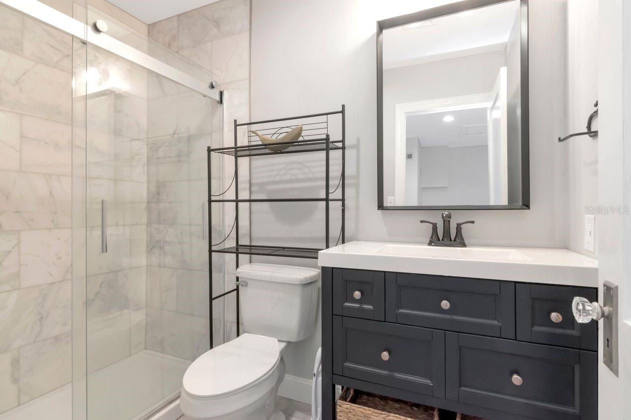 Full Bathroom 2nd Floor with Shower Stall fully tiled, sliding glass doors, and custom vanity.