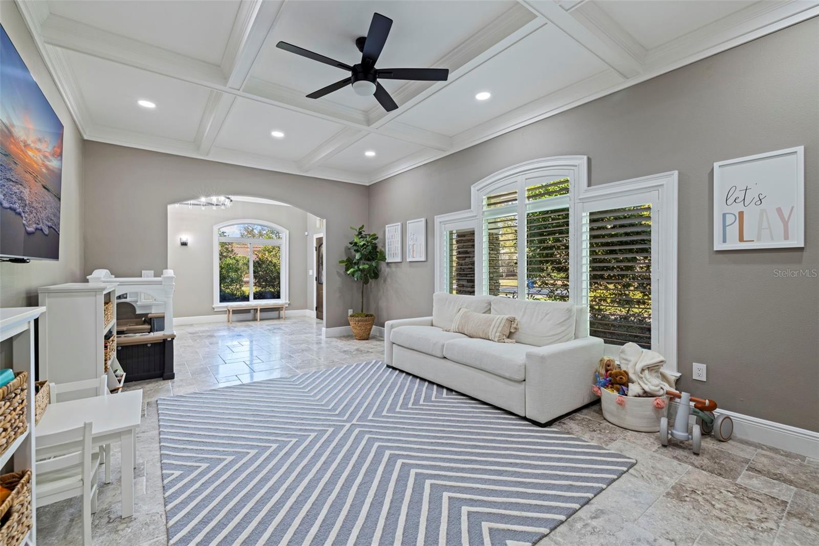 Additional living space with large windows overlooking outdoor area