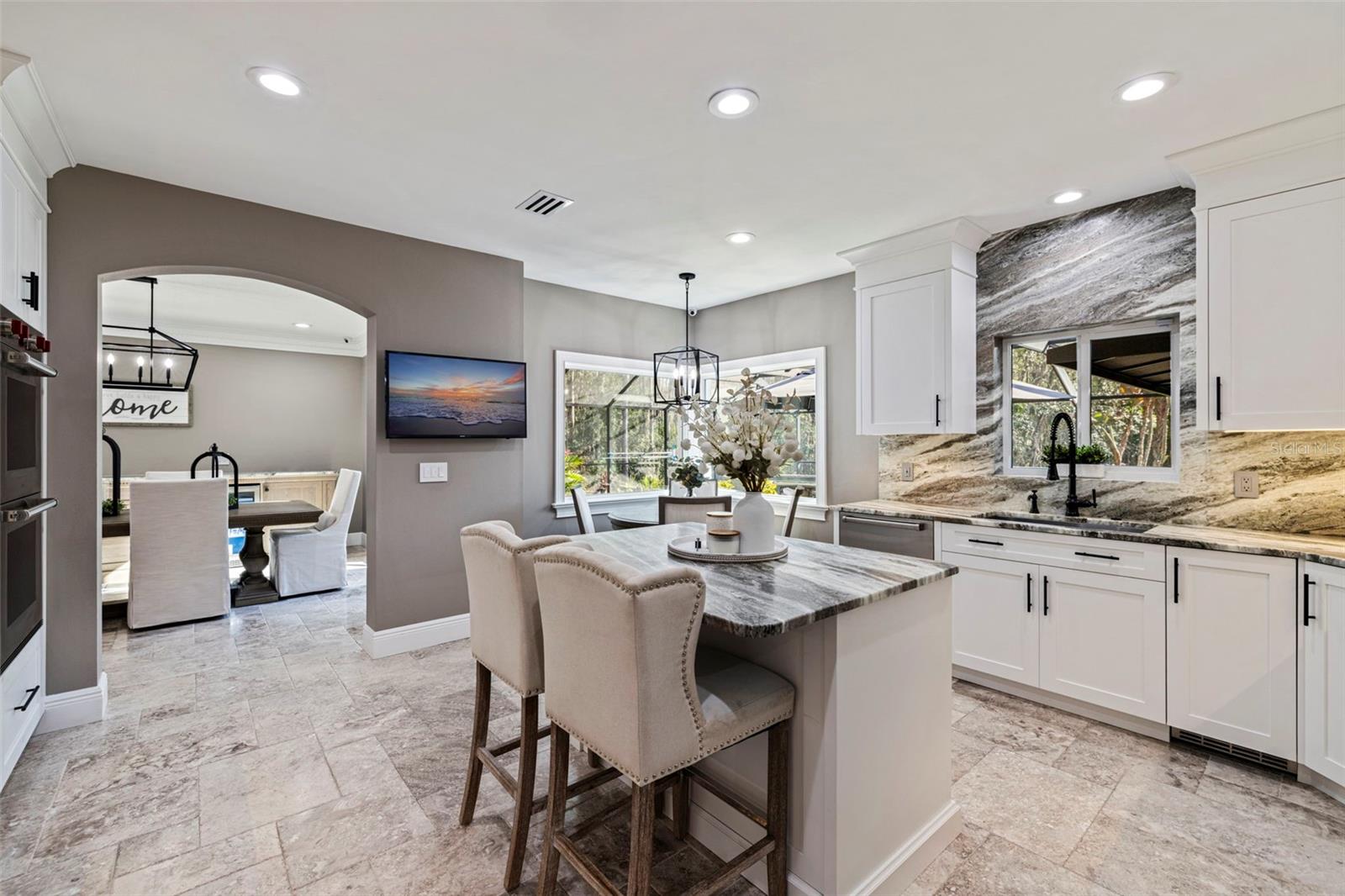 Gourmet kitchen featuring large island, custom cabinetry, and premium finishes