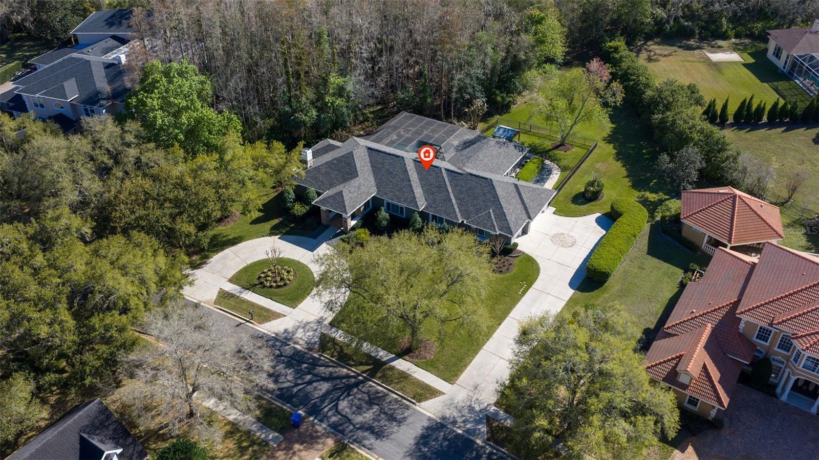 Aerial view showcasing expansive lot, privacy, and lush surroundings