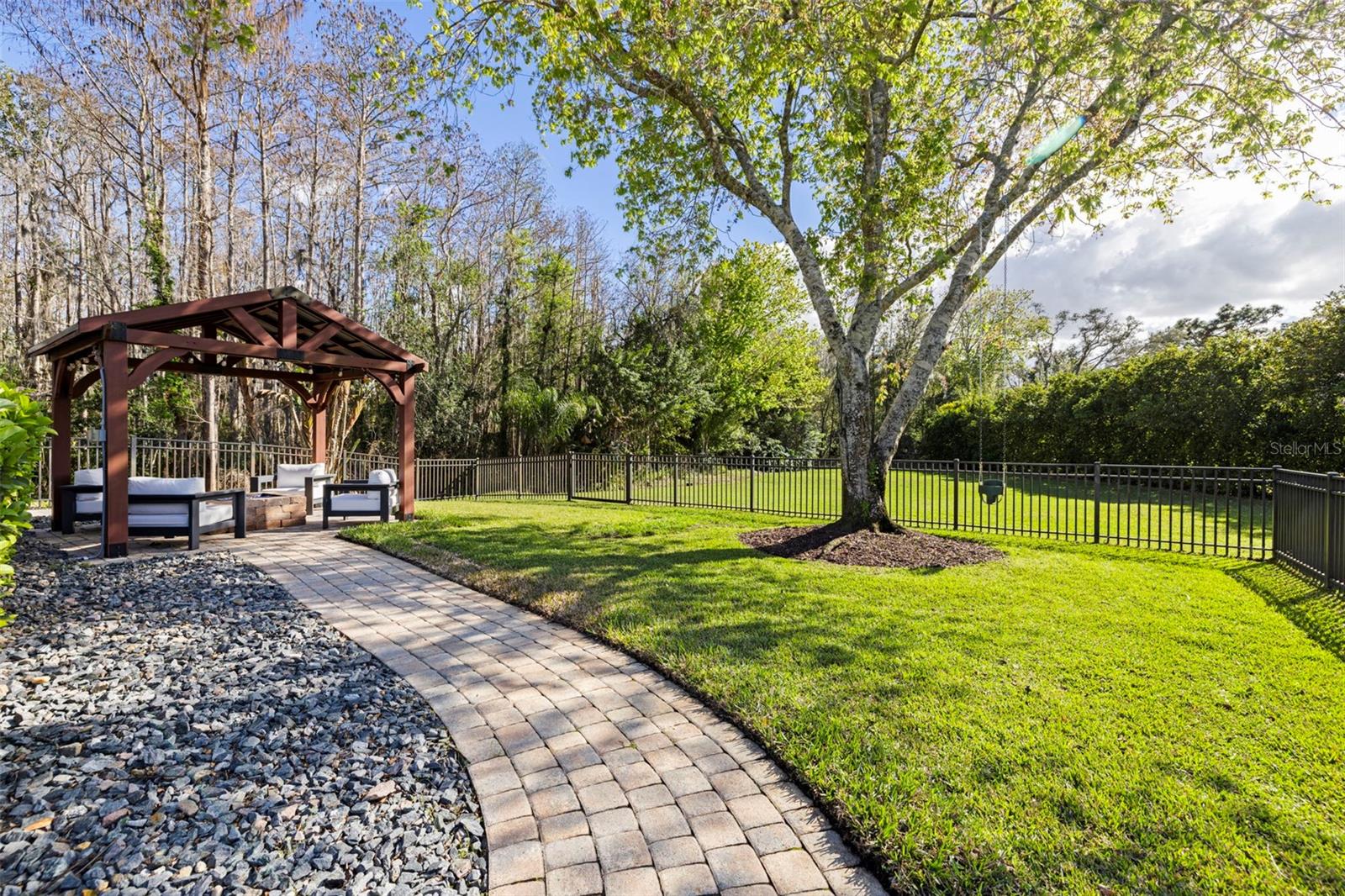 Expansive backyard with mature landscaping and serene setting