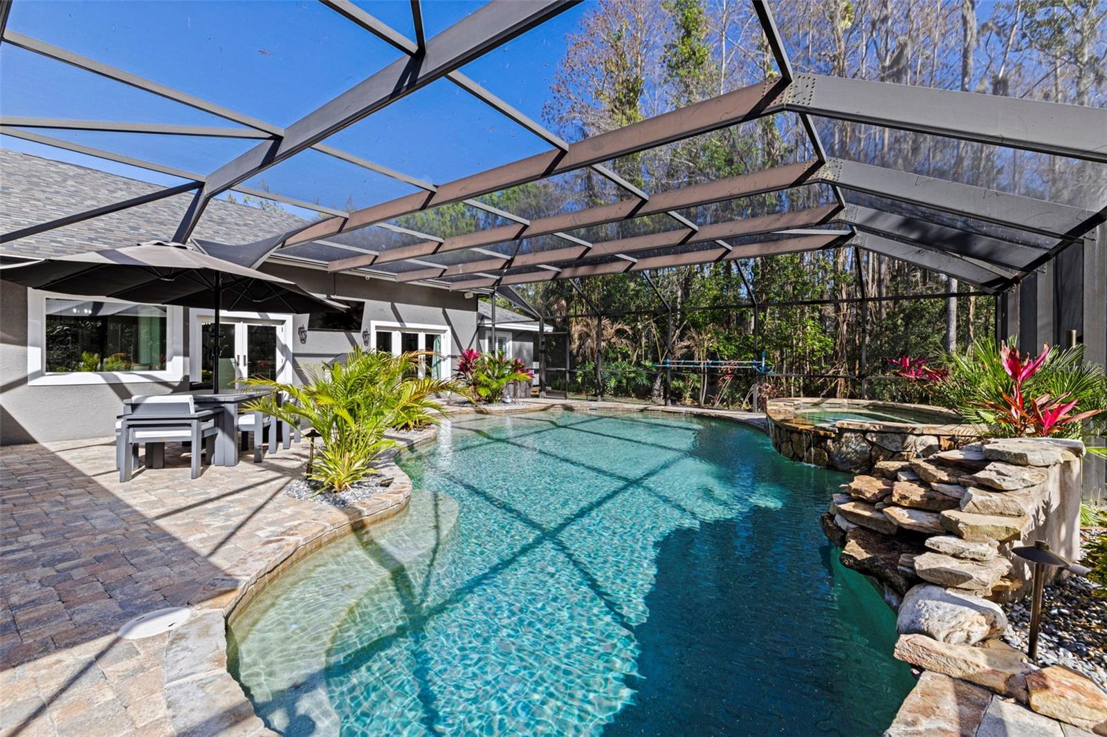 Screened pool and patio area offering indoor-outdoor Florida living