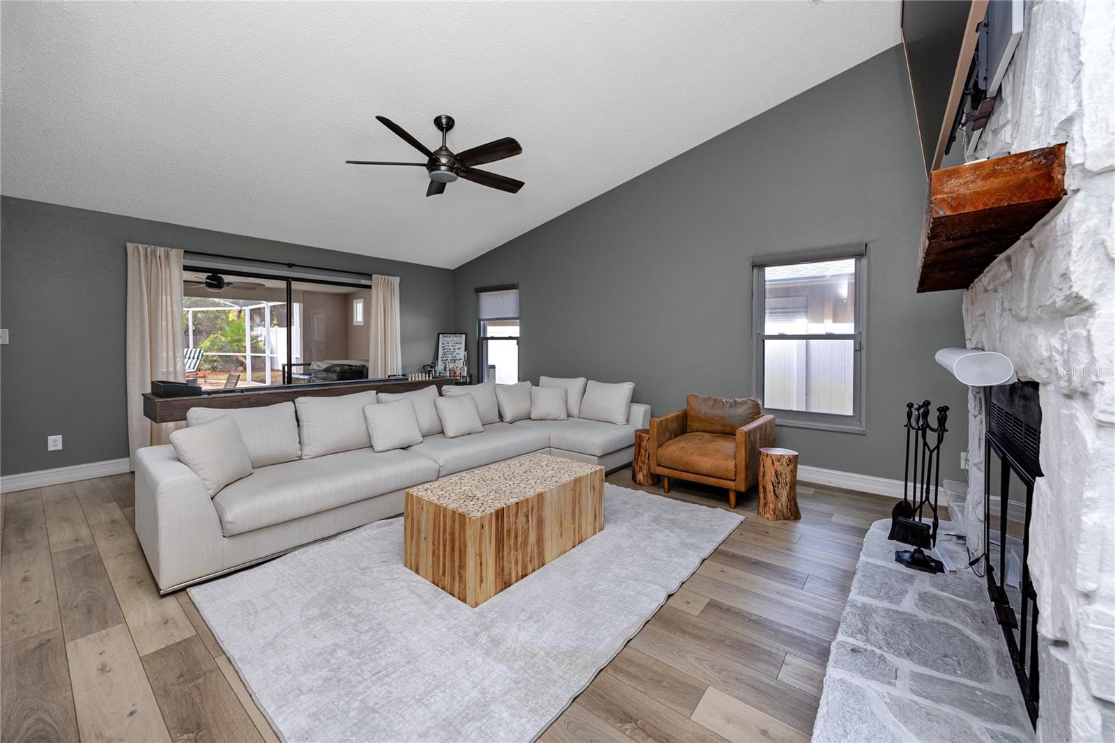Large 2nd living room with vaulted ceiling and fireplace.