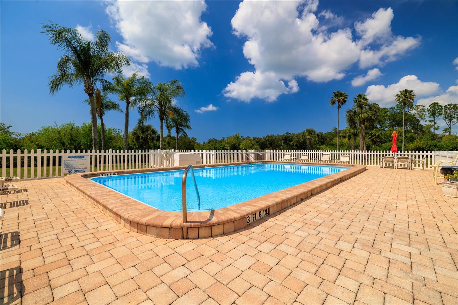 The sparkling, heated pool with beautiful pavered pool deck offers plenty of space to lounge or gather with friends