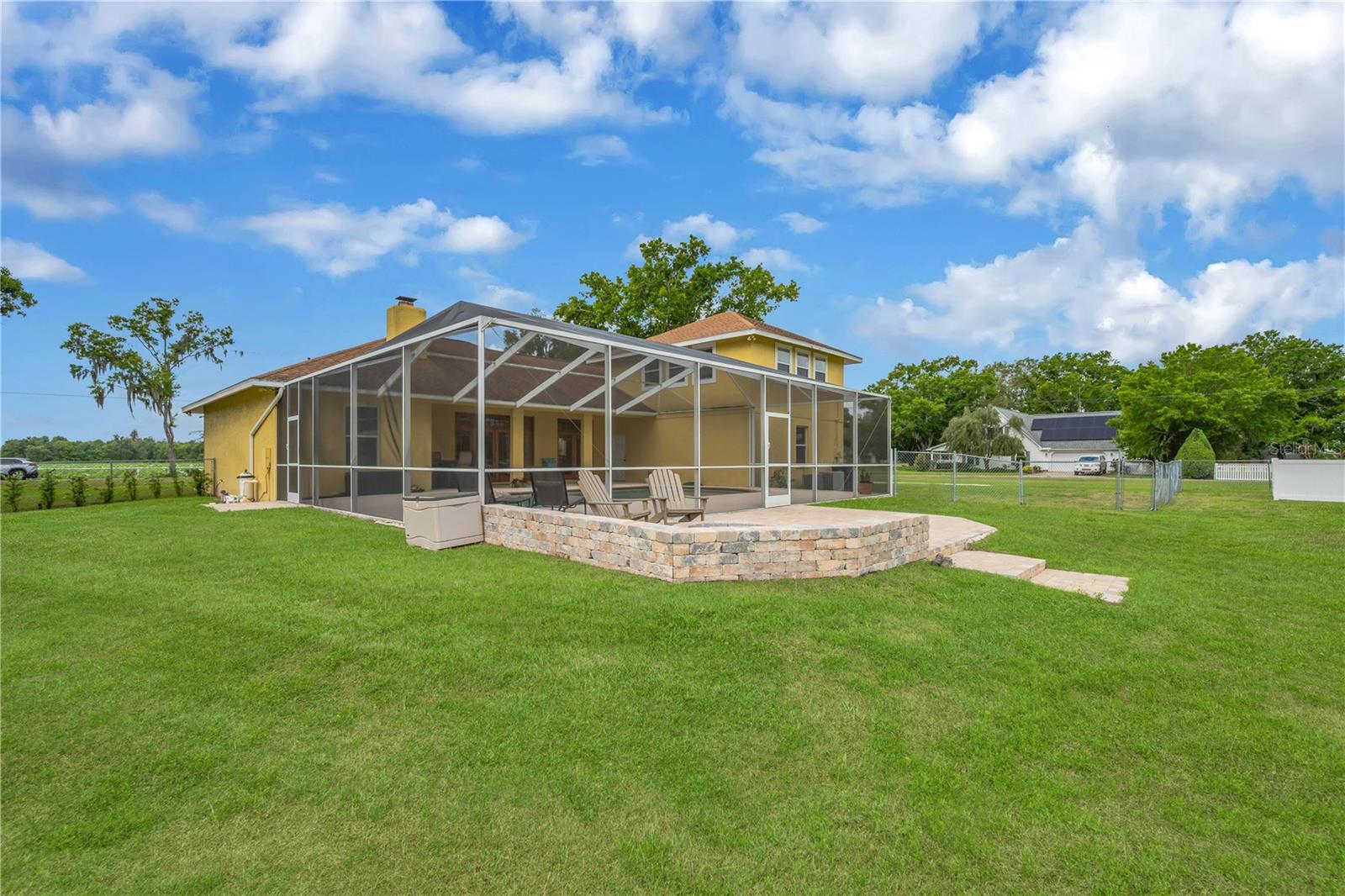 Back view of pool area and patio