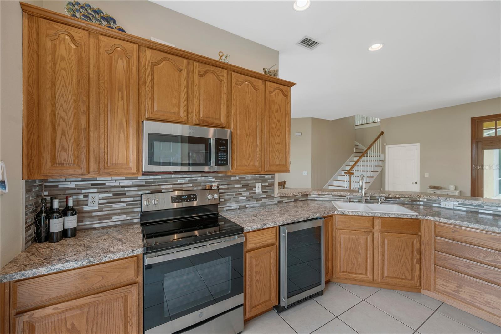 Stainless steel appliances include a wine refrigerator