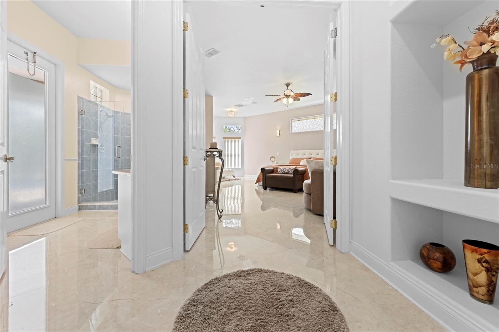 Foyer going to Primary Suite (Pool Bath to the Left)