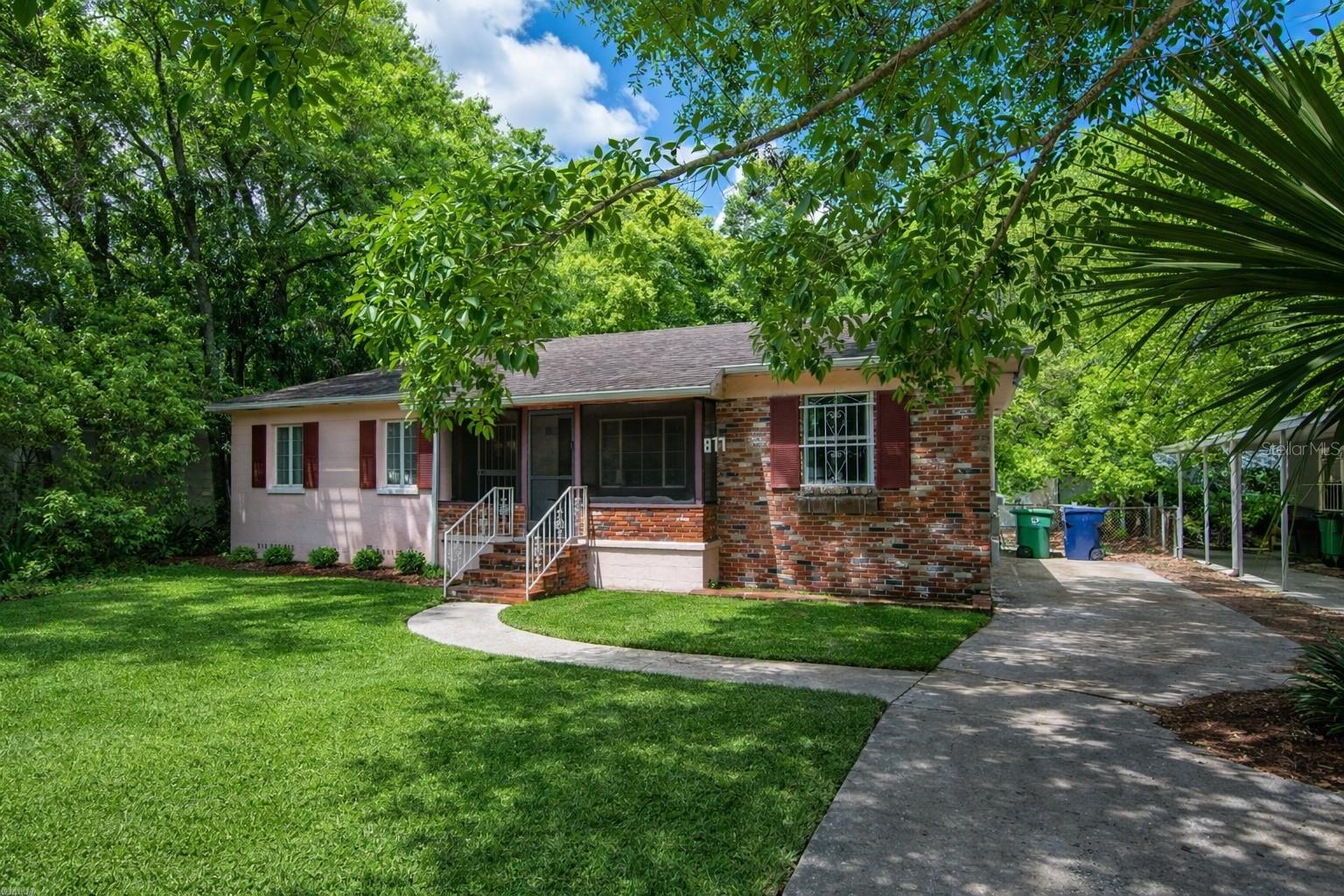Front exterior view of the home; landscaping has been digitally enhanced for presentation and marketing purposes.