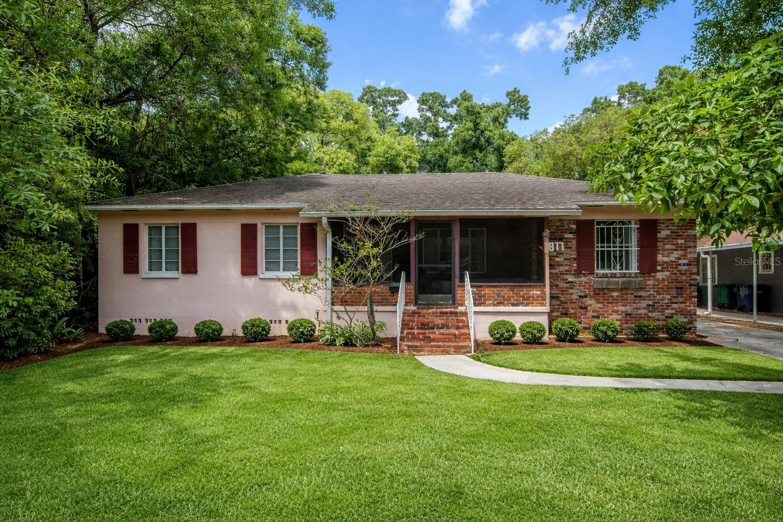 Front exterior view of the home; landscaping has been digitally enhanced for presentation and marketing purposes.