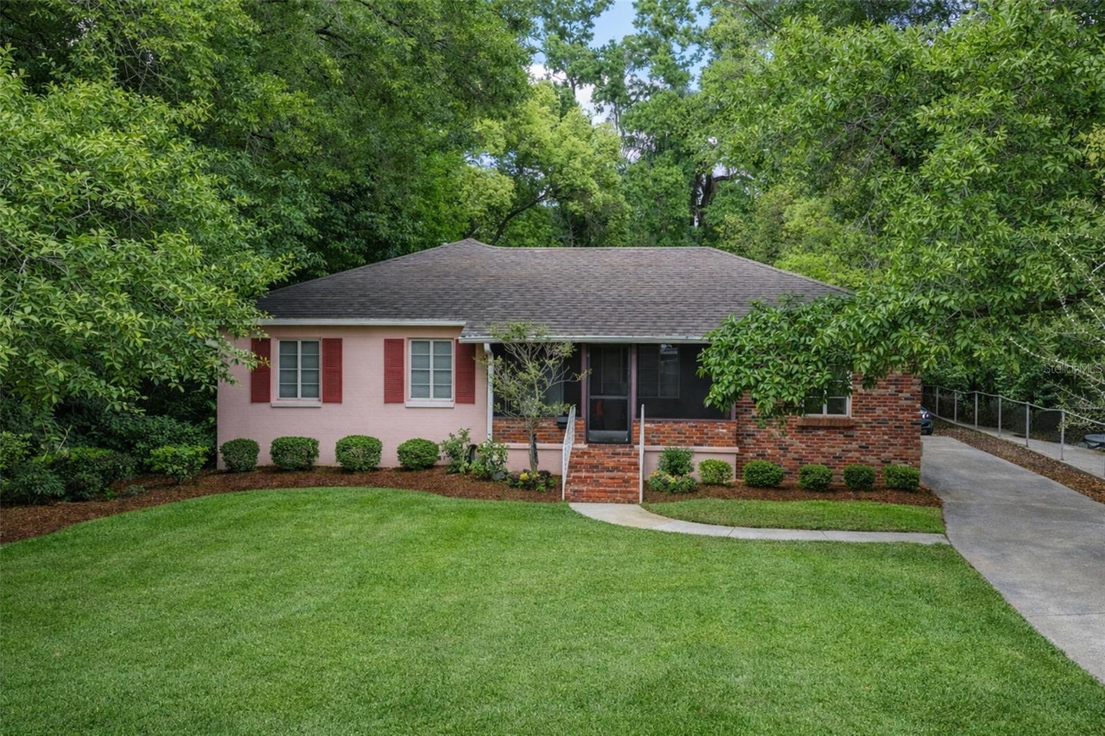 Front exterior view of the home; landscaping has been digitally enhanced for presentation and marketing purposes.
