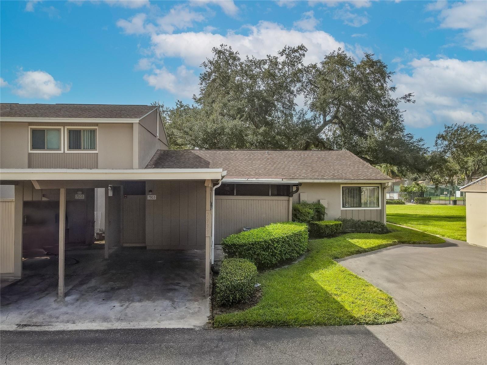 carport/rear view with additional parking