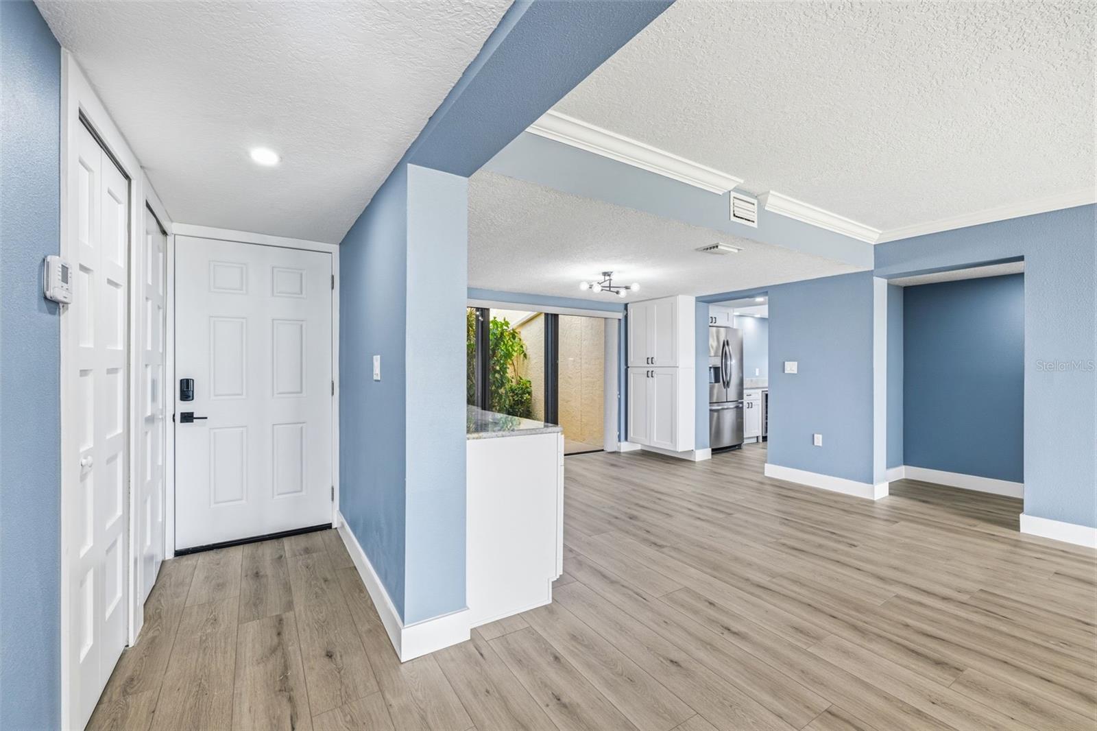 View from great room looking towards entry door and hall foyer