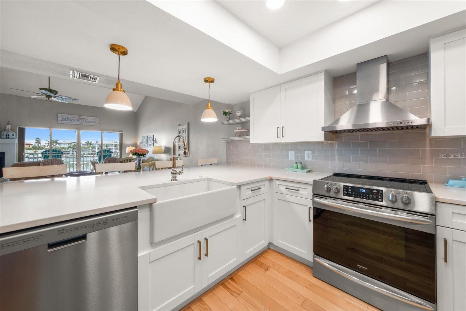 Modern finishes include stainless steel exhaust hood, high-end appliances, and stunning quartz counters.