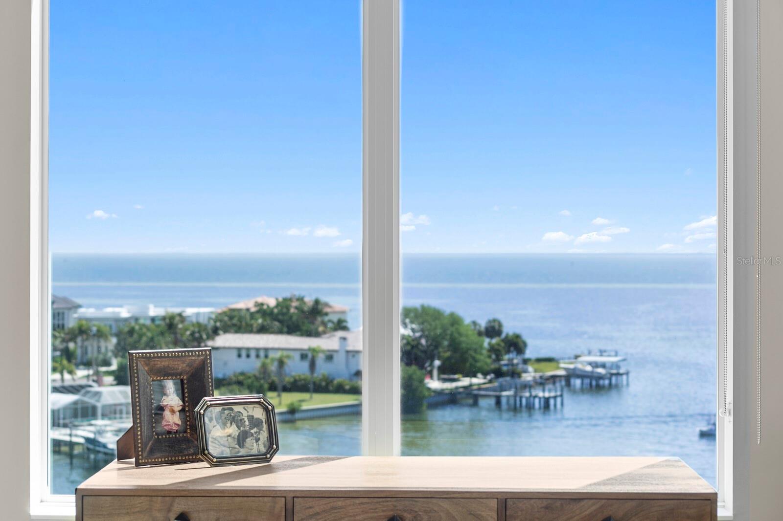 Primary Bedroom features an Beautiful Water Views, Ensuite Bathroom, Walk-In Closet, and Sliding Doors that open to Balcony