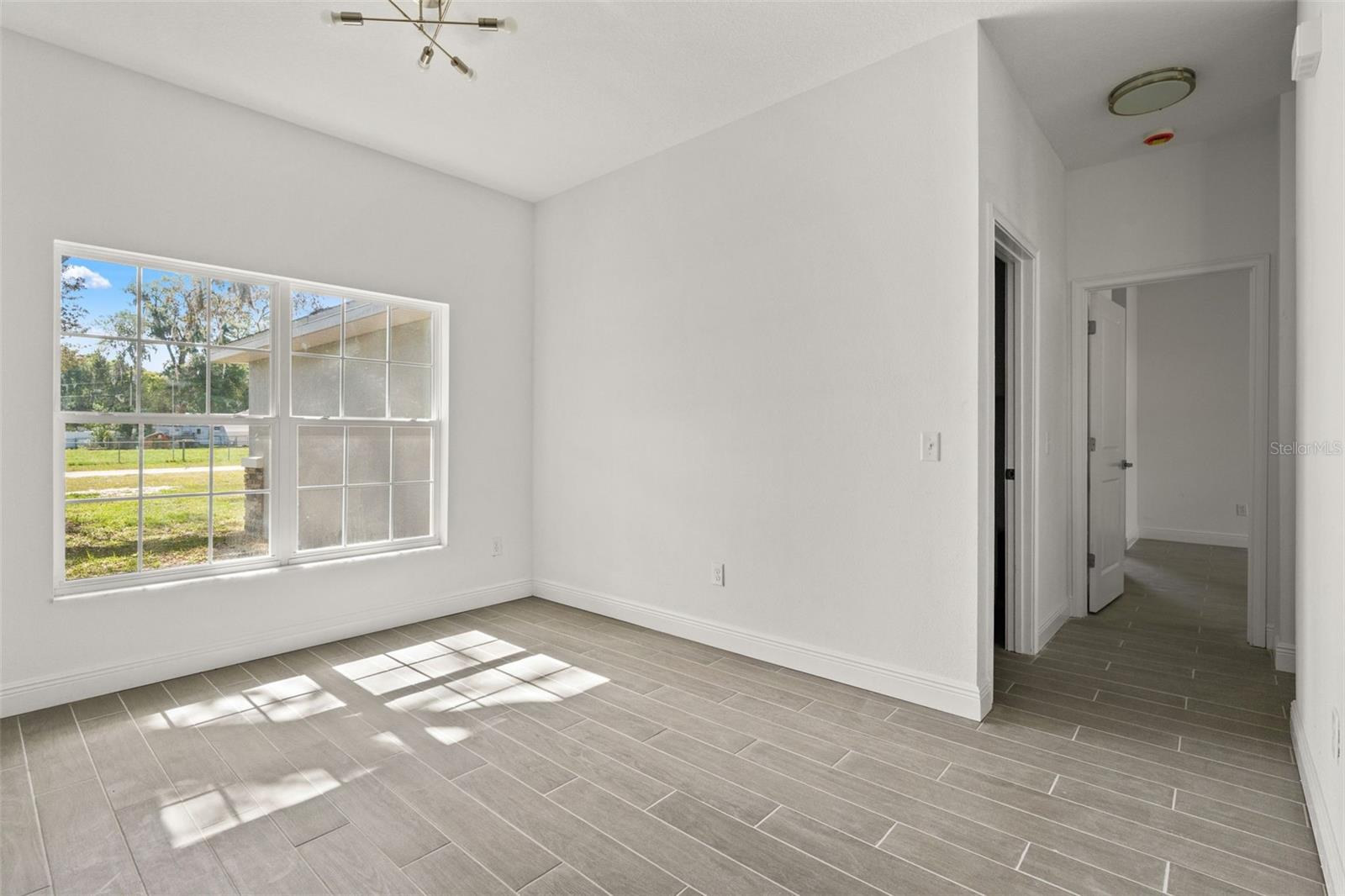 Flex area and/or formal dining. Hallway to laundry and primary bedroom