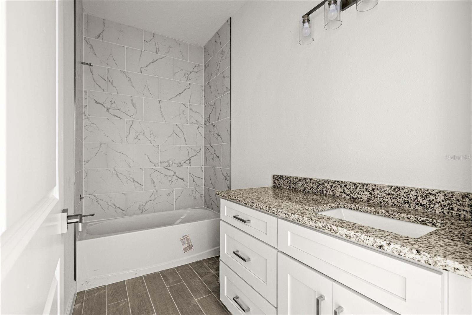 guest bathroom with tile shower/tub combo!