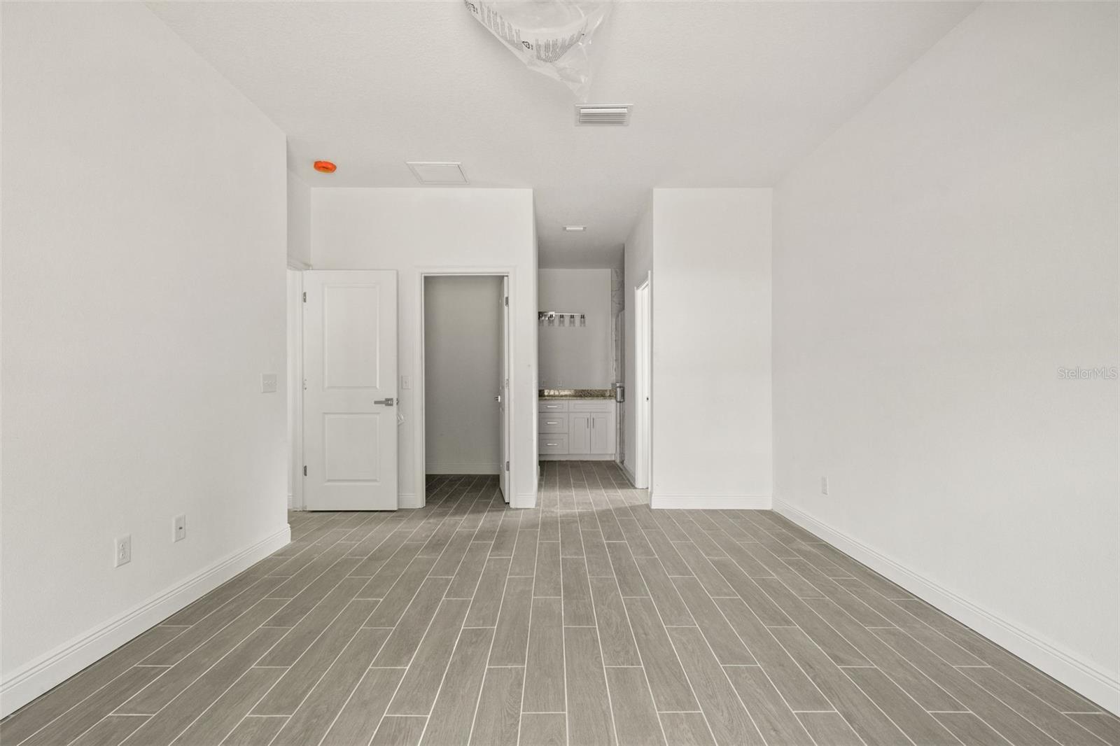 Primary bedroom with walk-in closet and ensuite bathroom
