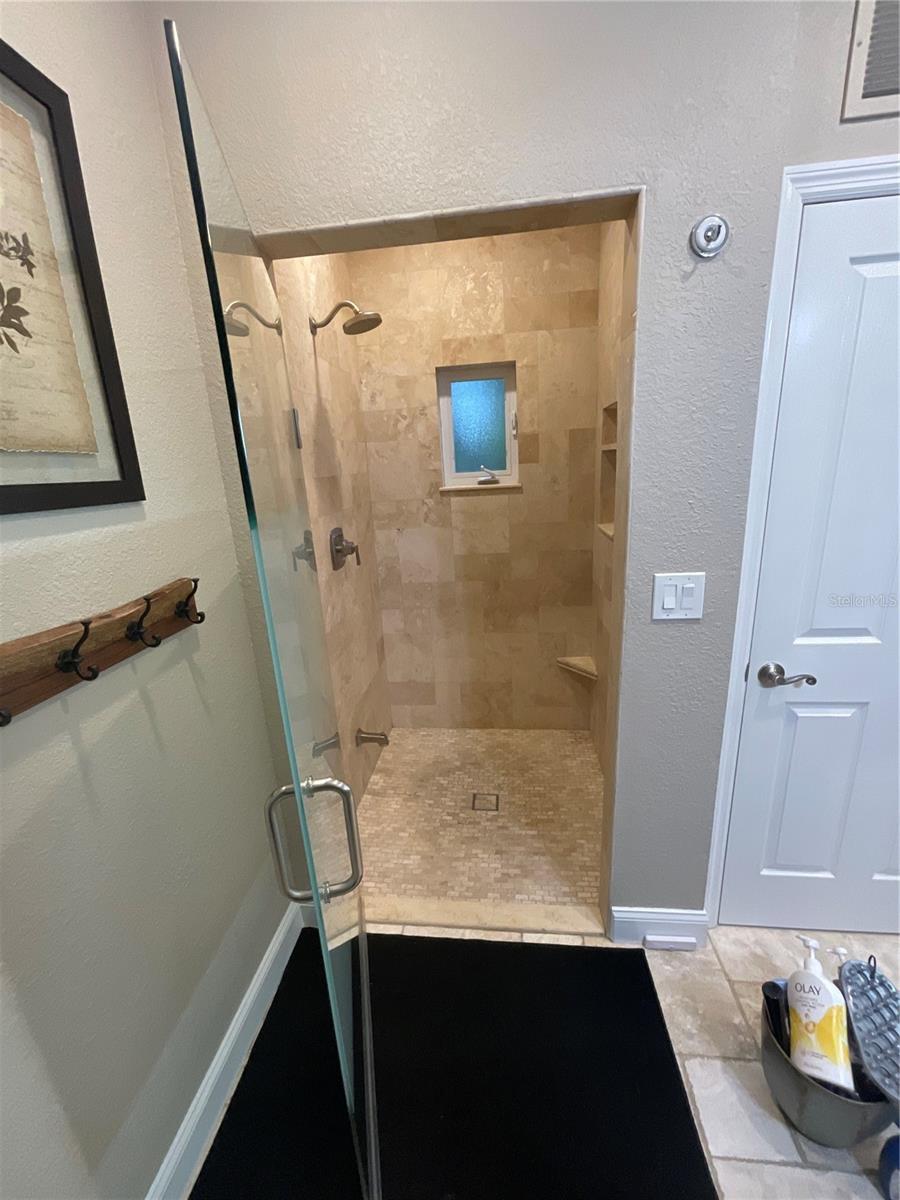 Primary shower… very spacious, travertine stone, window for fresh air if you choose.