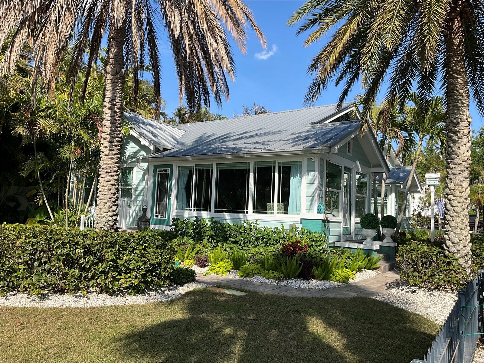 View from the lawn back towards the house and large bank of windows, as well as the front door