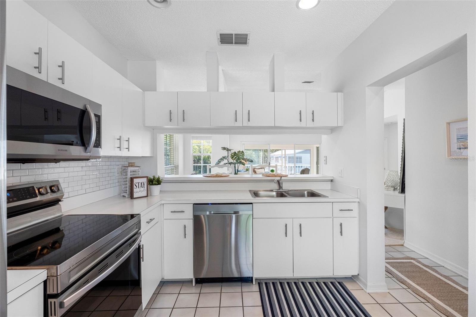 .. Kit Shot #4... Large 13.8 X 9.1 Kitchen.. Plenty of Natural Light.. Coffee Notch .. Breakfast Bar.. Plenty of Cabinet Space..