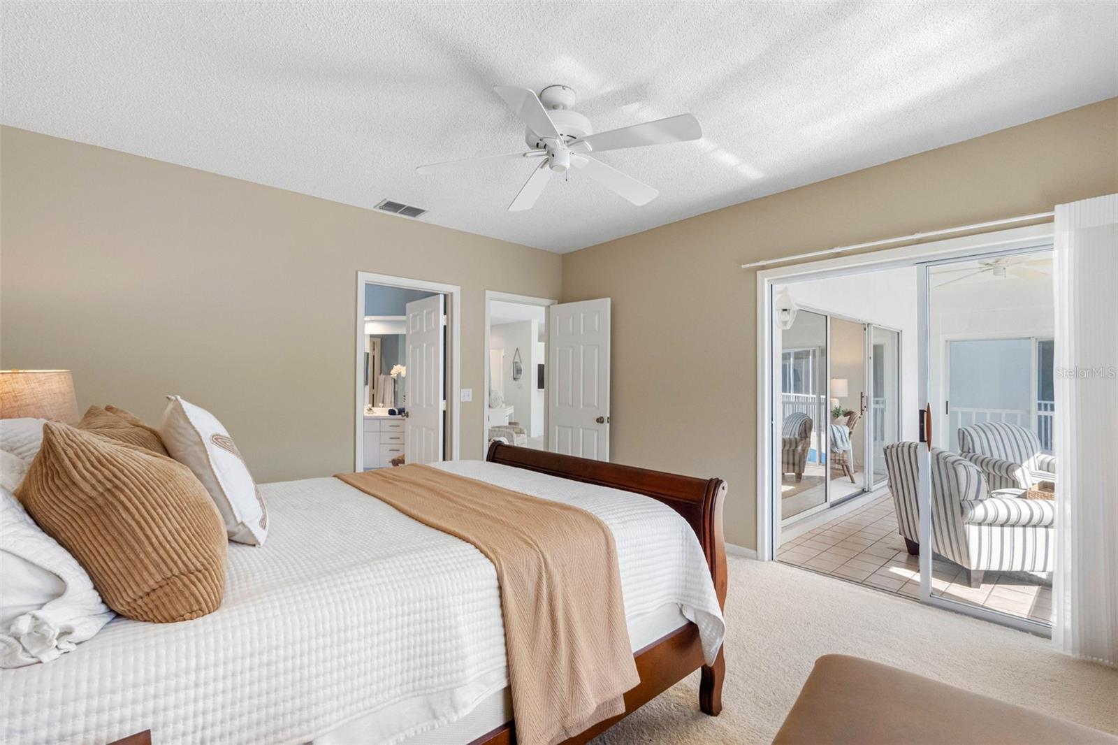 .. Master Bedroom with Balcony Access.. Open  6 Panel White Door to Living Room Area..