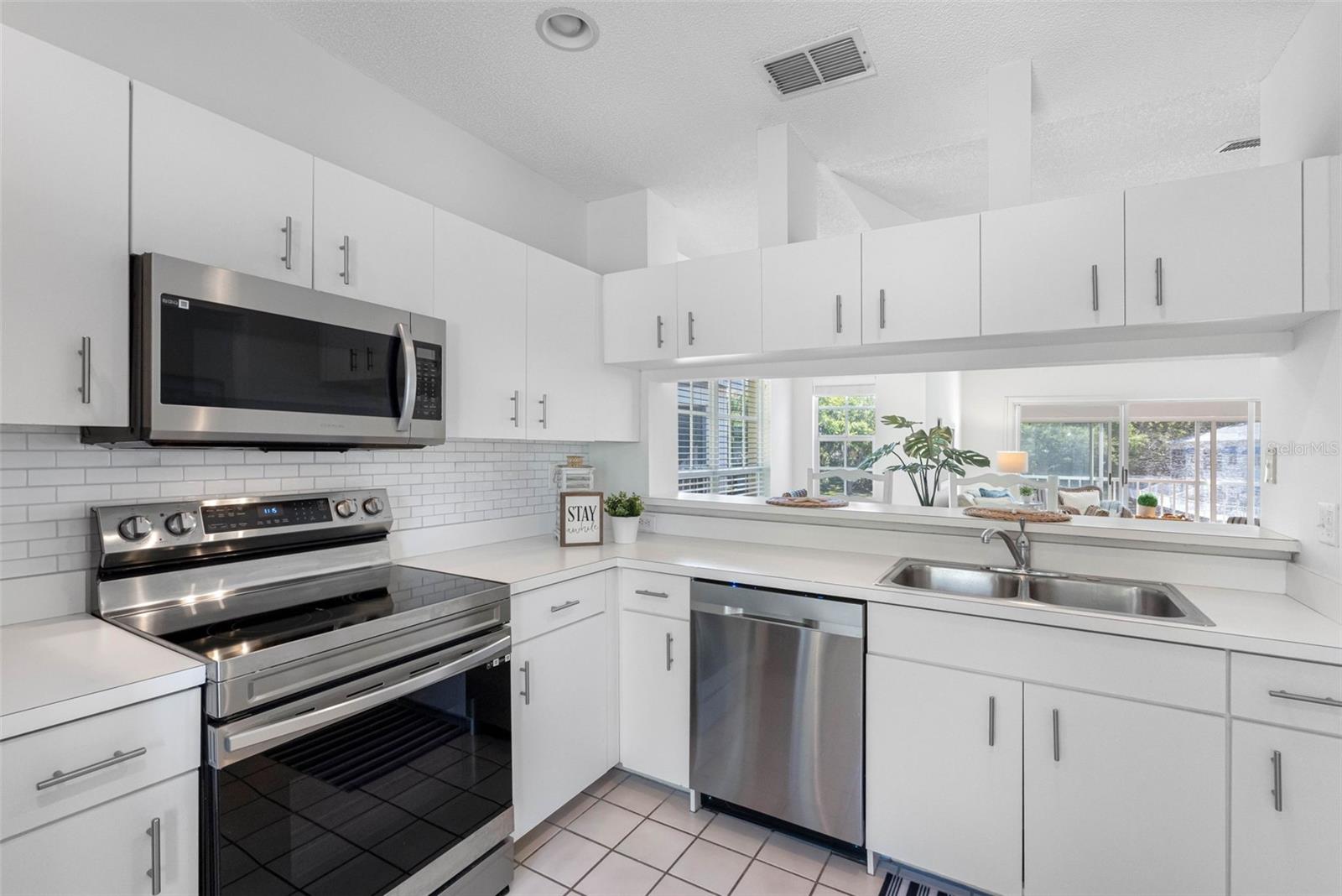 ..Kit # 3 Large 13.8 X 9.1 Kitchen.. Plenty of Natural Light.. Breakfast Bar.. Plenty of Cabinet Space.. Photo Looking out...