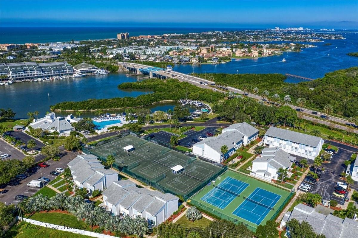 ... Shipwatch Looking North..  With Aerial of Clay Tennis Courts - Pickle Ball Courts - and Marina. The Bridge to Indian Rocks Beach at Top of Photo, There are 20 Restaurants Right over the Bridge. The Main Clubhouse and Olympic Pool can be seen at Photo Top By the Intracoastal Waterway. The Entrance is By the Bottom of the Bridge..