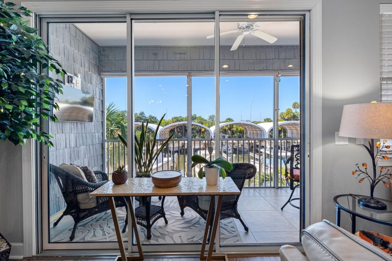 Balcony with a mounted TV and water views.  Enjoy your morning coffee while gazing out at what could be your own ?? boat sitting there waiting for you.