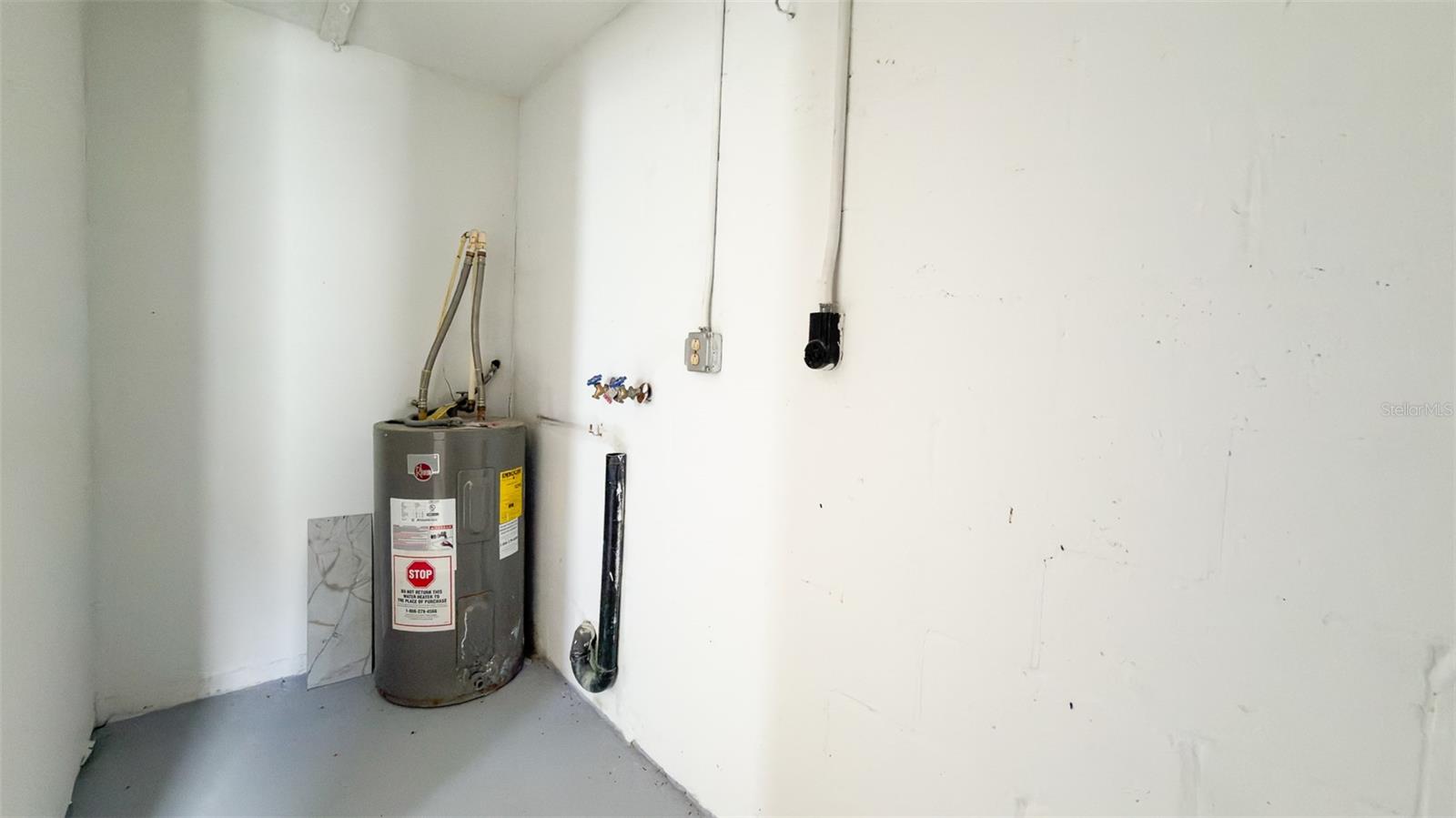 Laundry and Water Heater in Garage