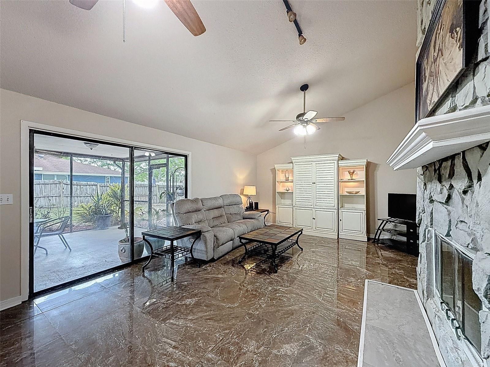 Huge living room leading to a large slider to the large screened-in patio.