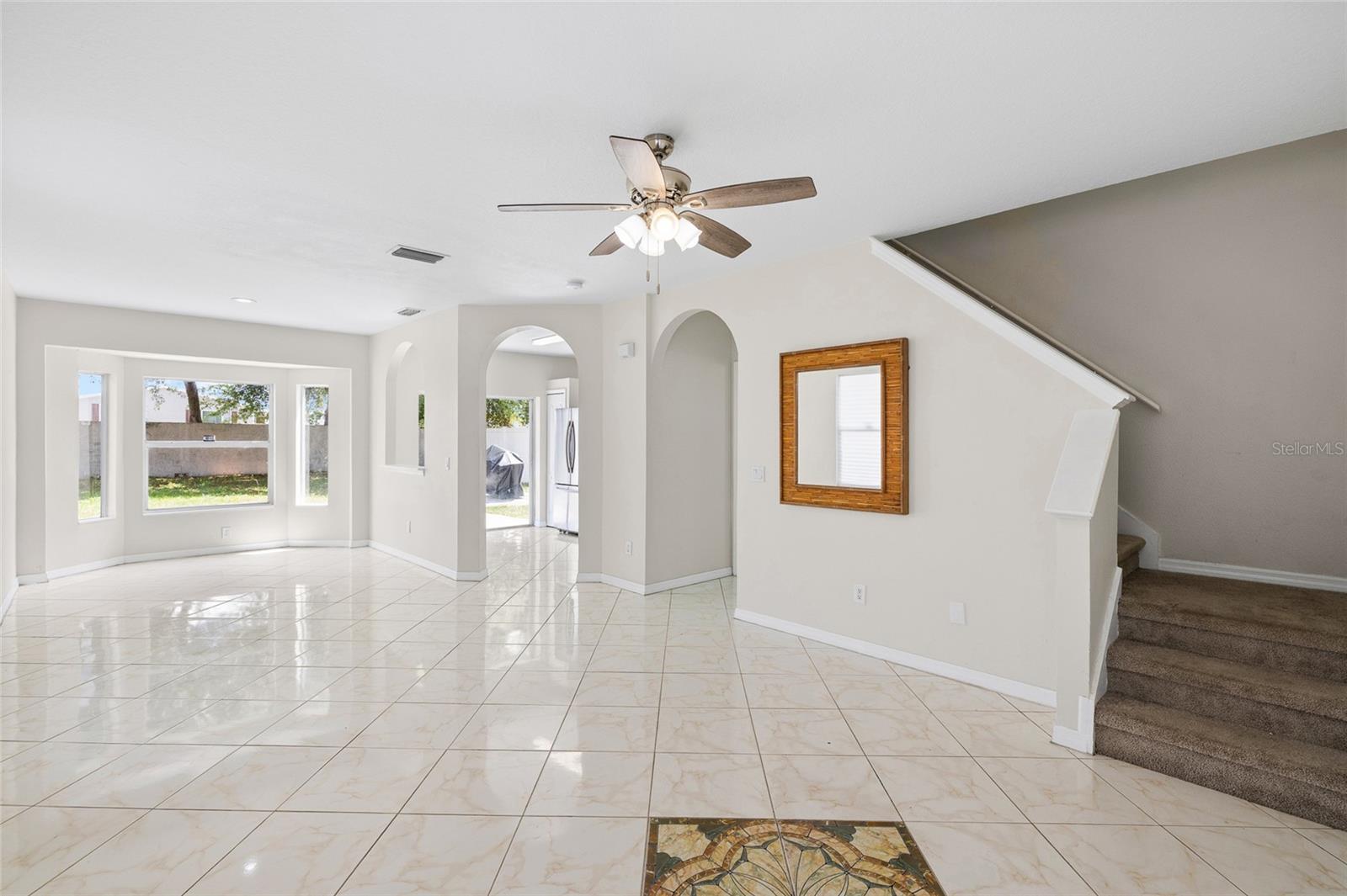 Enter the garage to the right or head upstairs to 3 more bedrooms.