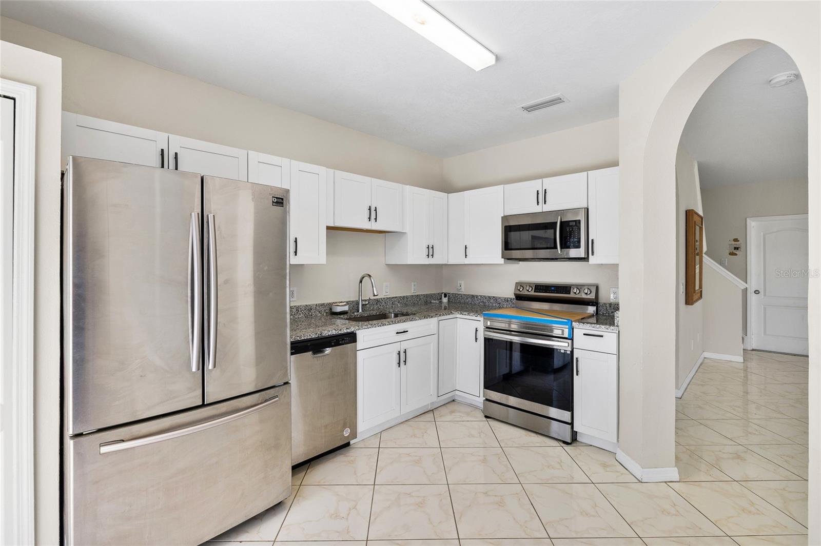 Kitchen has a closet pantry, lots of cabinets and granite counters