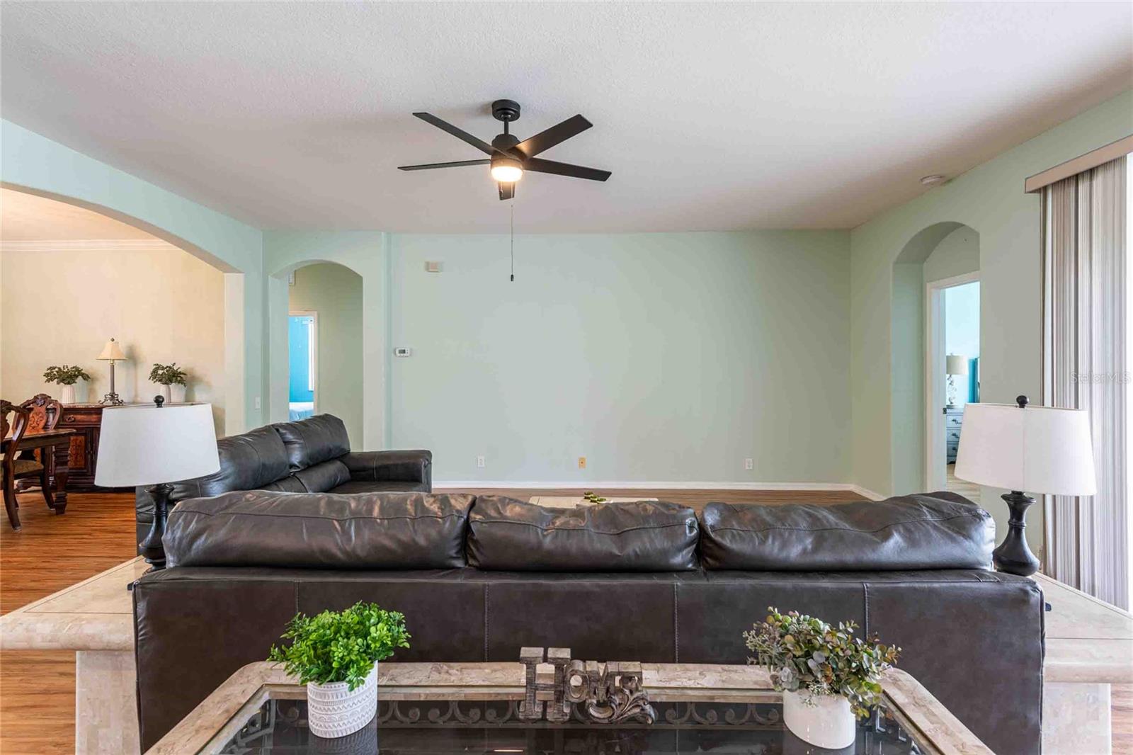 Spacious great room. The primary bedroom is off the right, and the secondary bedrooms are off the left.