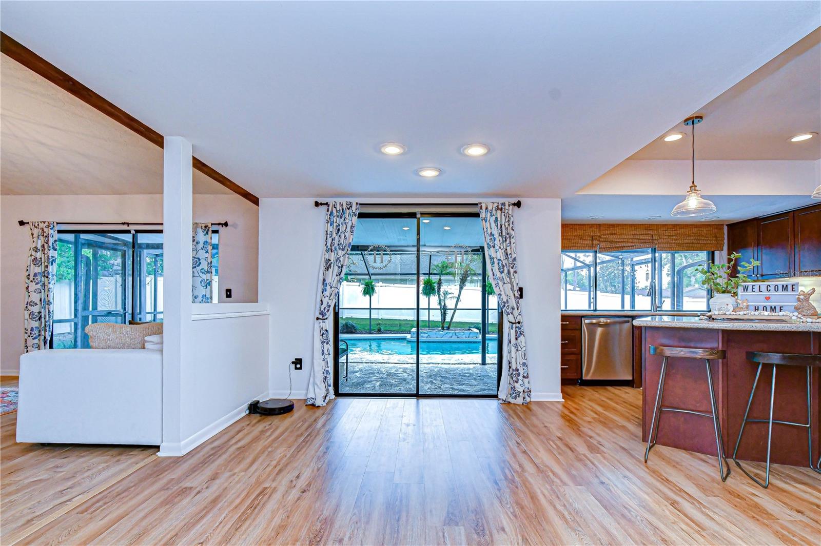 Kitchen window connecting directly to outdoor bar seating. French doors leading to lanai.