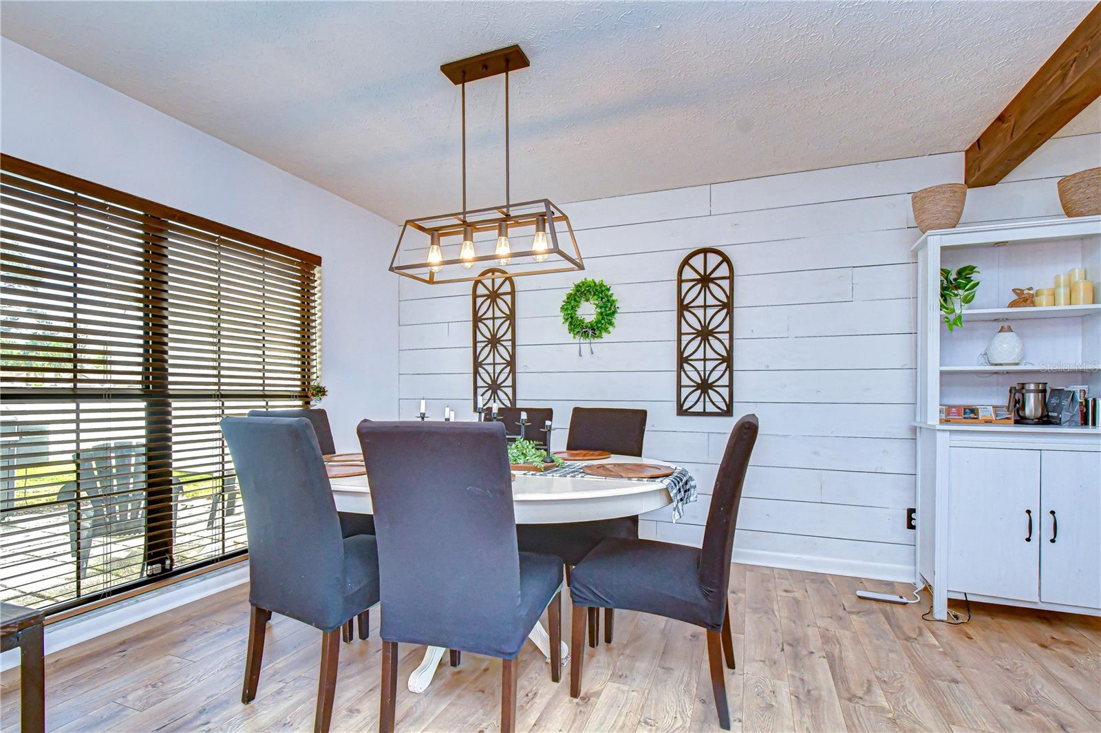 Dining area featuring stylish shiplap accent walls.