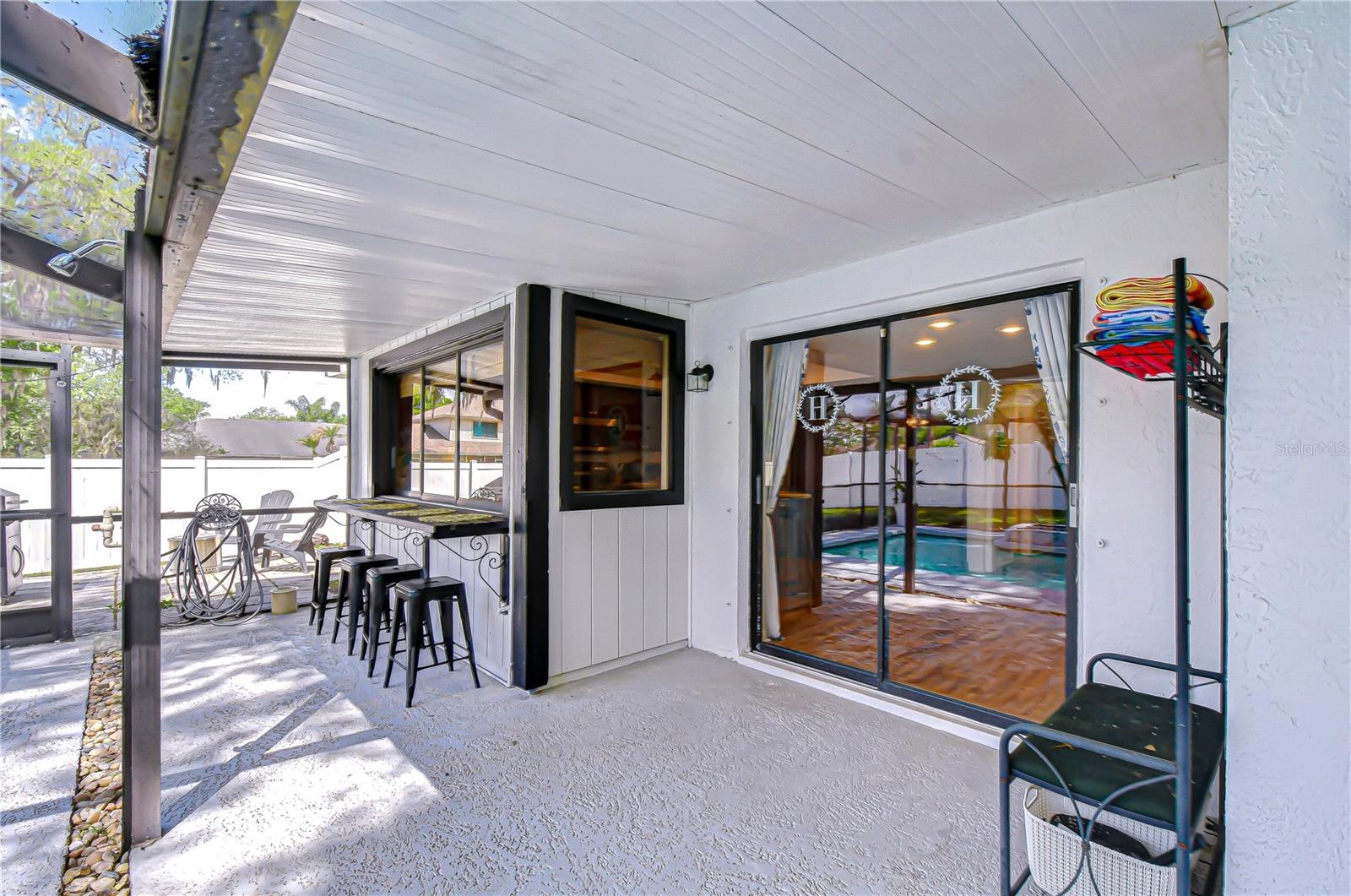 Kitchen window connecting directly to outdoor bar seating.