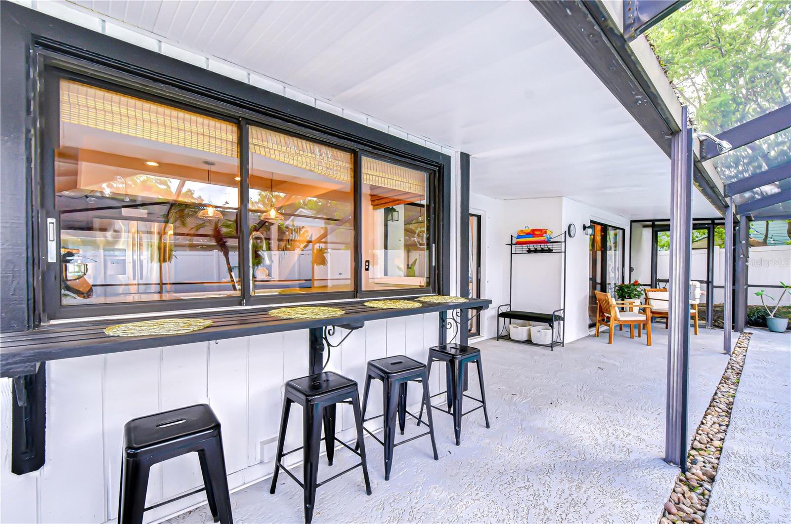 Pass-through window creating poolside bar area.