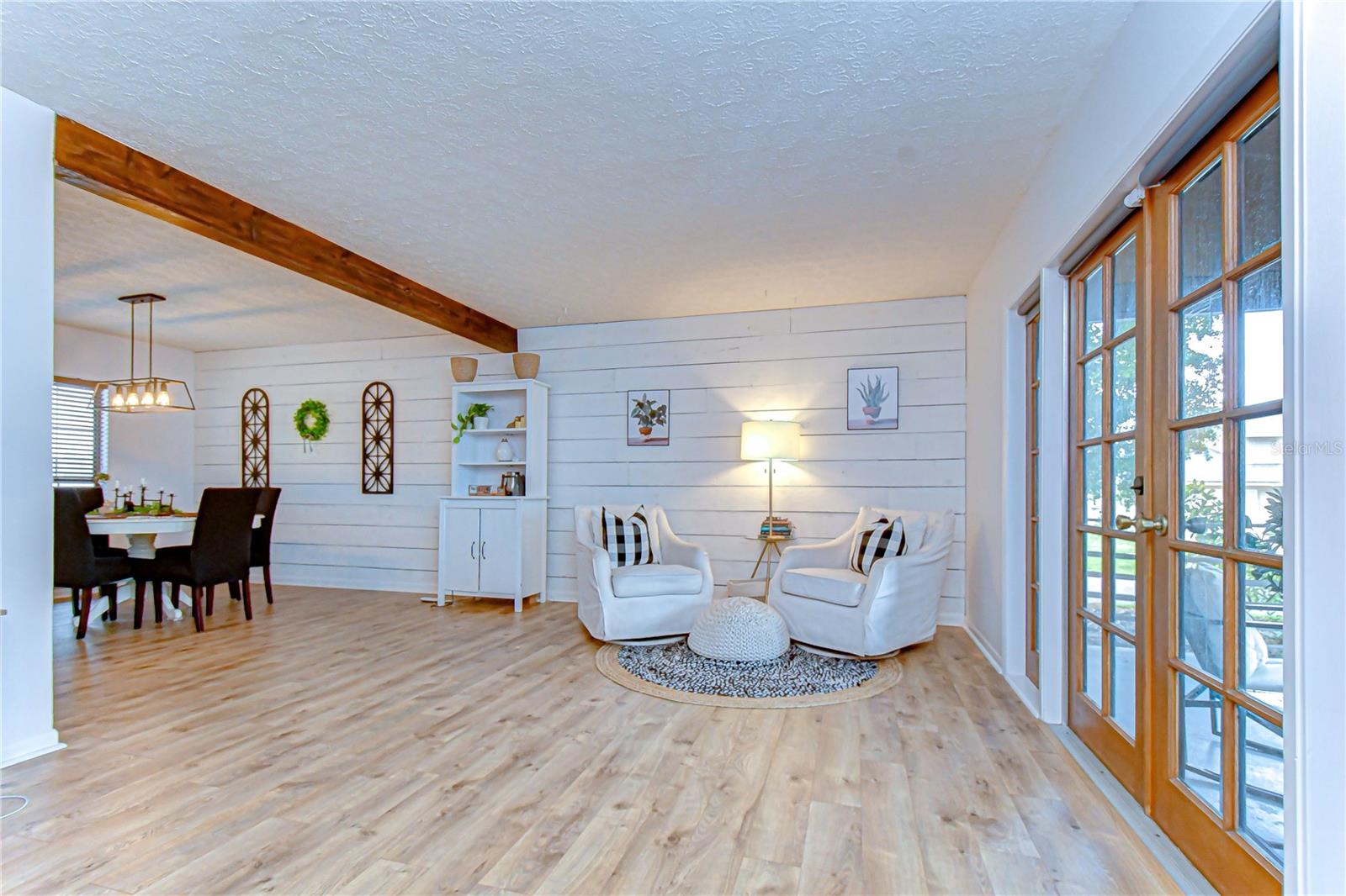 Bright living room with French doors leading to the front porch.