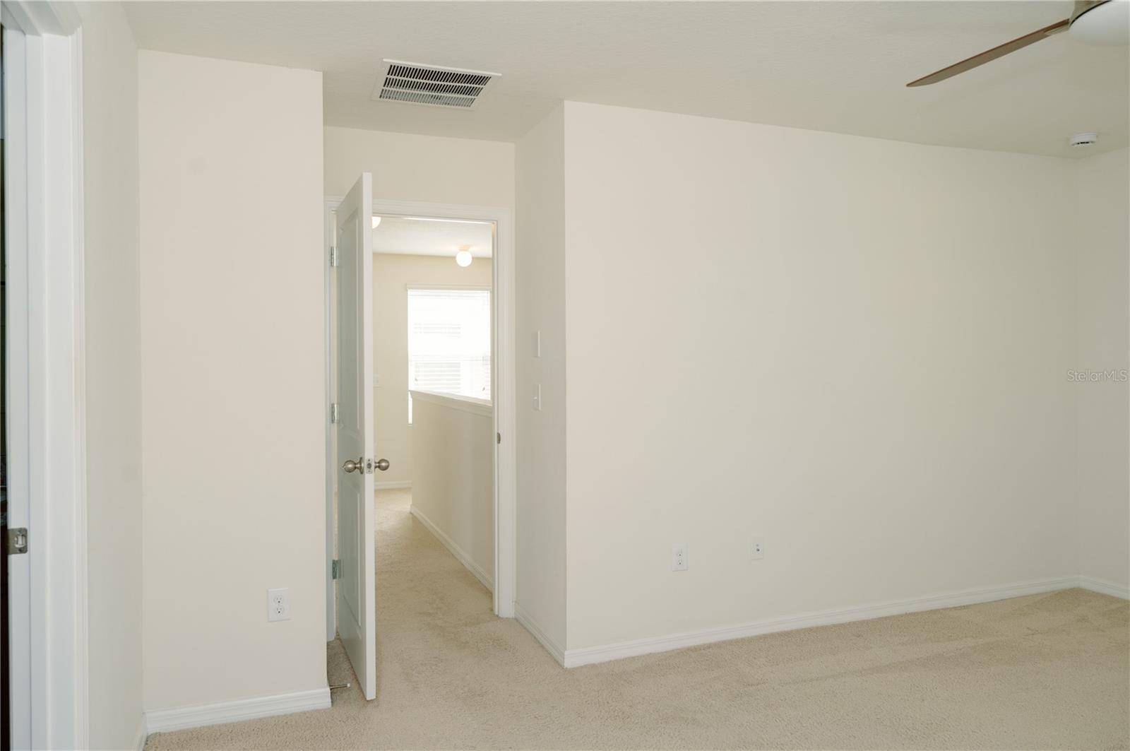 View from primary bedroom looking at entry door to hallway