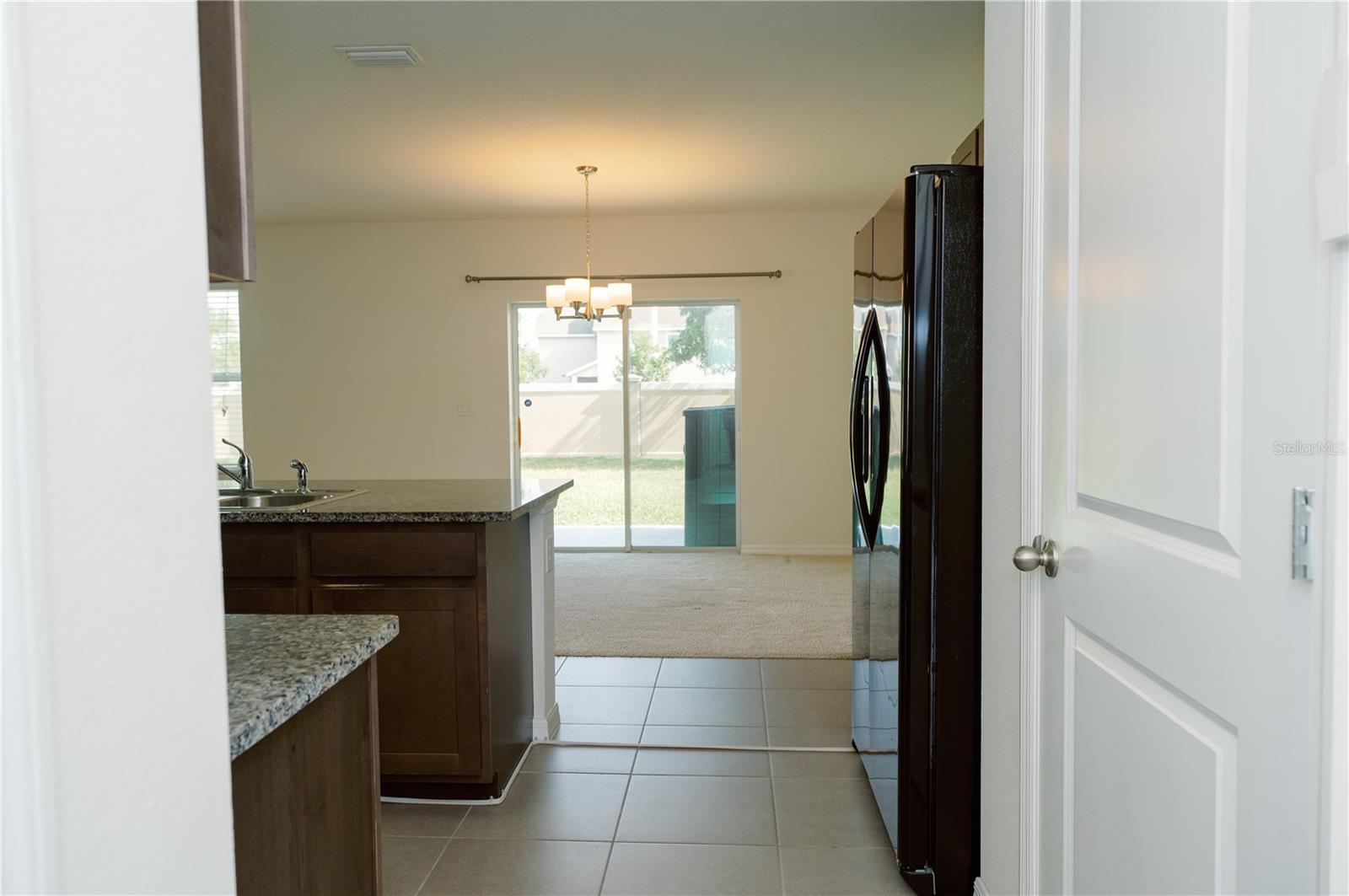View from garage entry door looking at dinning area and sliding glass door