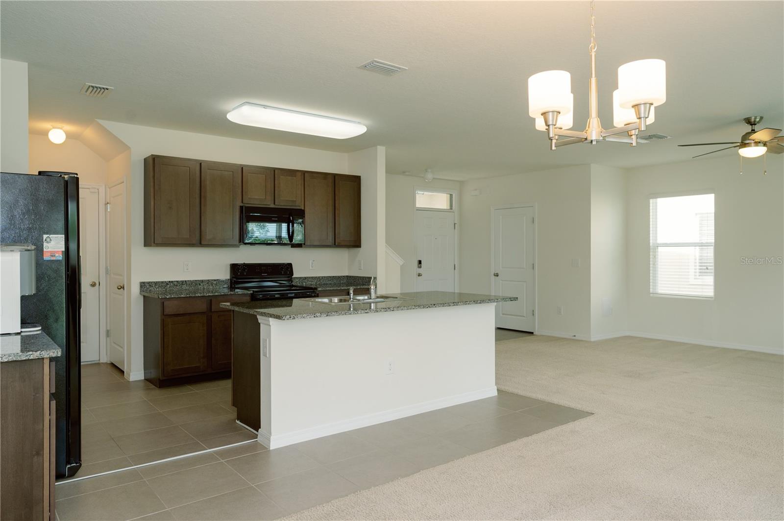 View from dinning arae looking back to front door and half bathroom