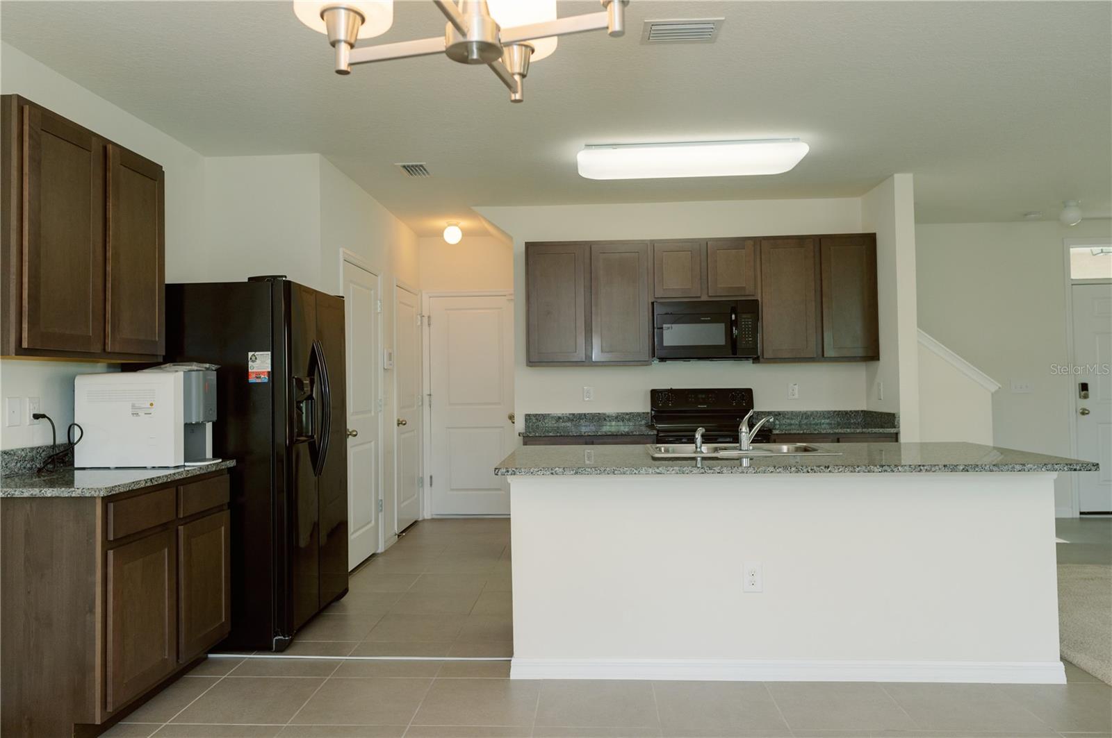 View from the dinning area looking back to pantry, closet and garage doors