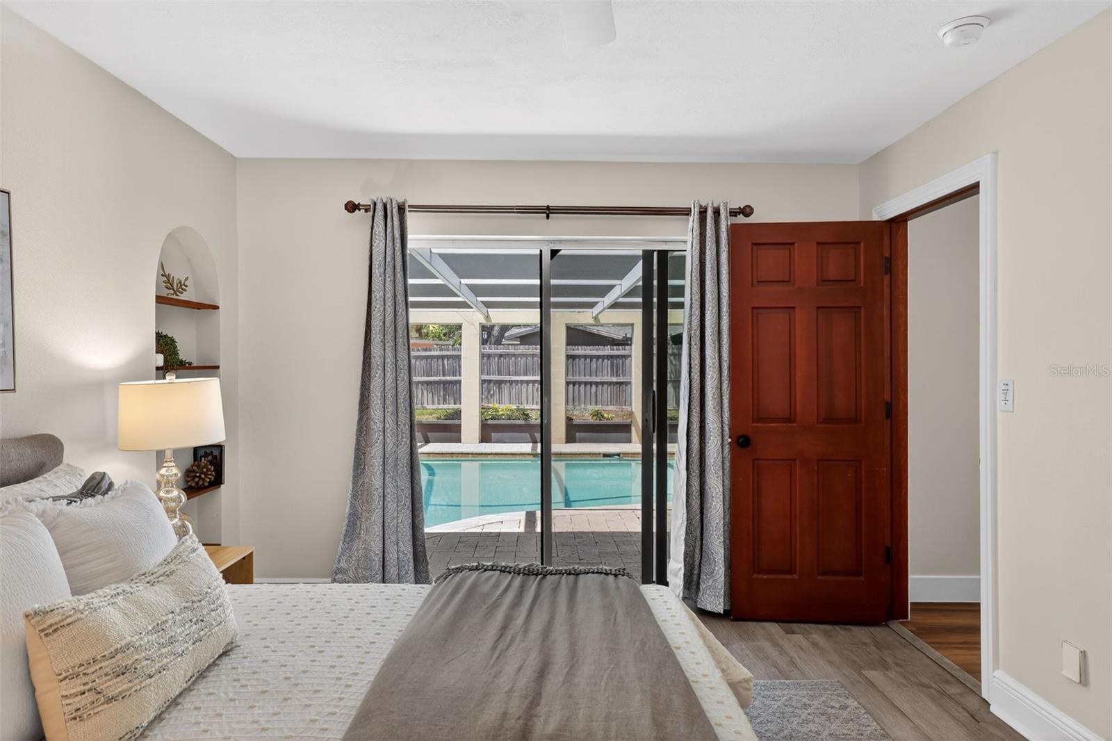 Pocket sliding glass doors out to the pool from the primary bedroom
