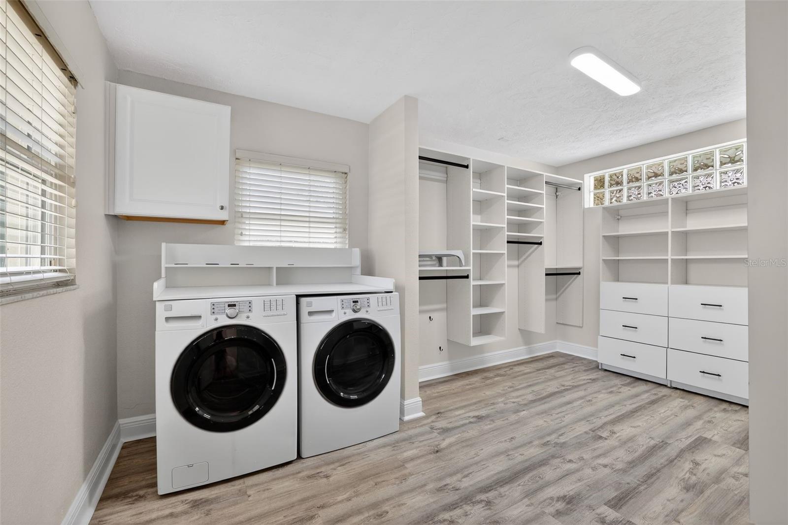 Laundry located in primary bedroom walkin closet